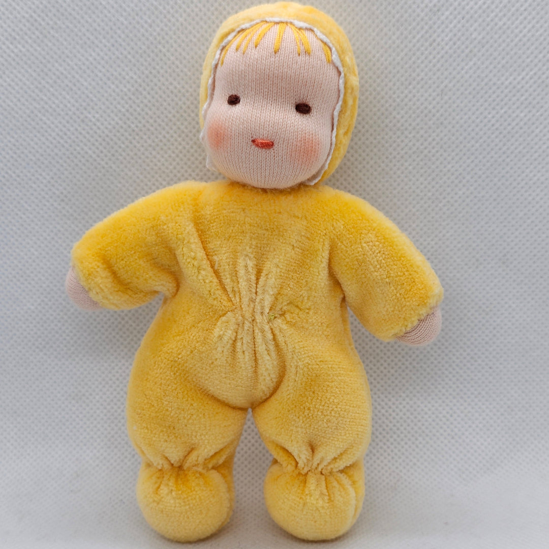 Yellow plush toy with a face on a white background