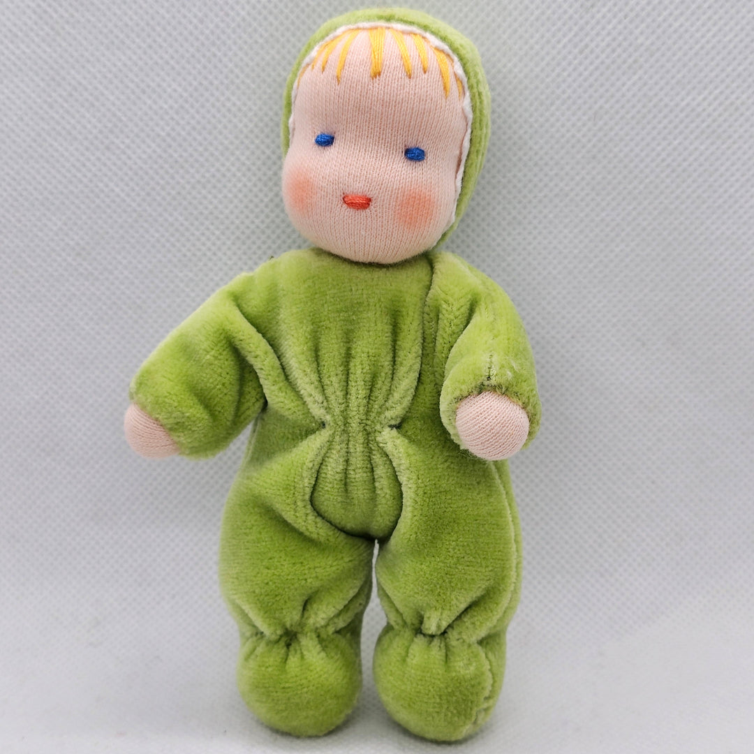Small green plush toy with a face on a light gray background